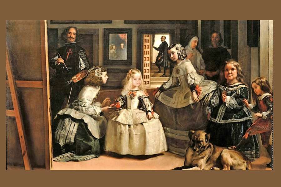 reprodukcja obrazu przedstawia infantkę Małgorzatę i dwórki w bogatych strojach, a także malarza i parę królewską odbitą w lustrze w ciemnobrązowym wnętrzu