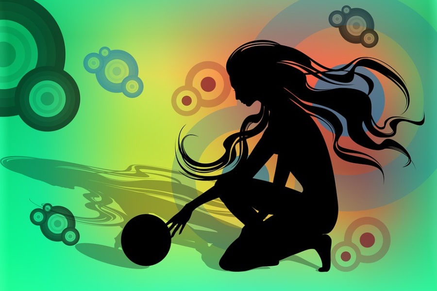 Zdjęcie przedstawia postać kobiety klęczącej z piłką w ręku. Tłem jest odbicie postaci z barwnymi kołami różnej wielkości.
